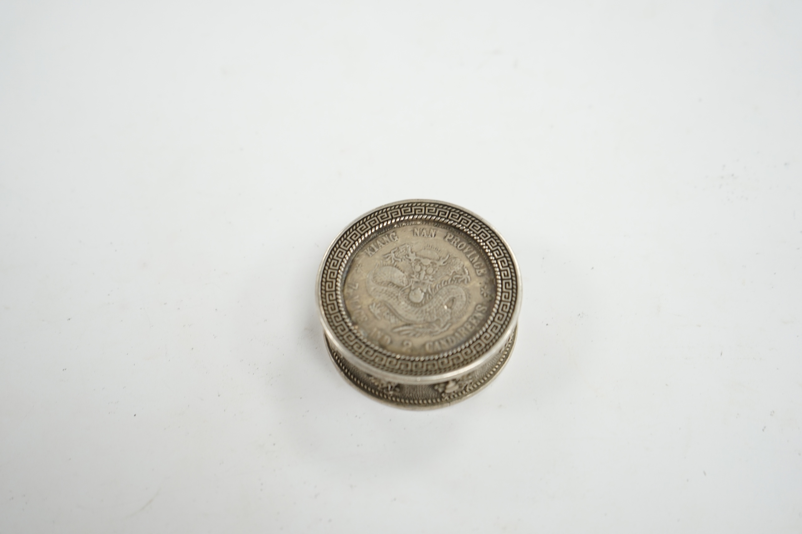 A Chinese white metal coin box and stamps, coin box 5cm diameter. Condition - coin box interior marked, stamps appear fair